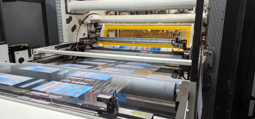 High-speed industrial printing machine producing colorful packaging materials with precision in a manufacturing facility